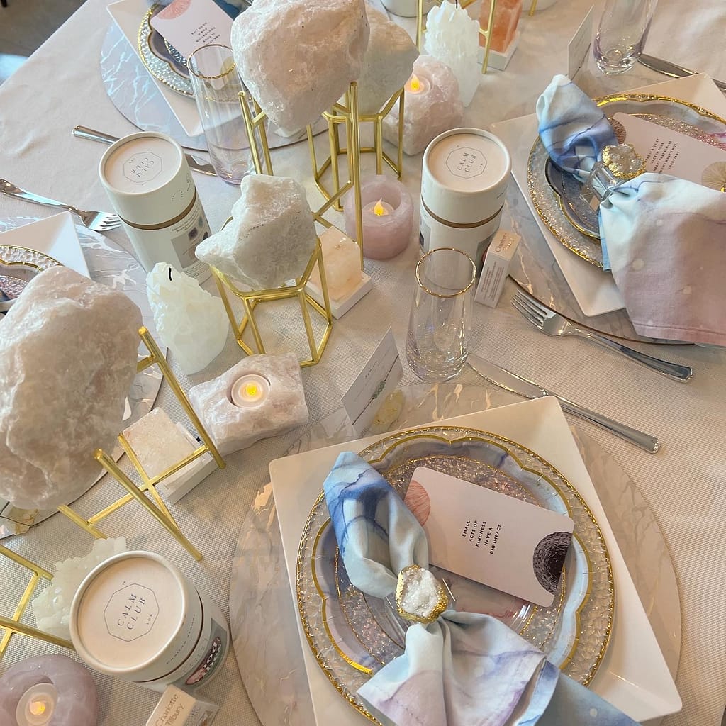 Tabletop decorated in periwinkle and lilac, with soft candlelight and beautiful crystals sprinkled throughout.