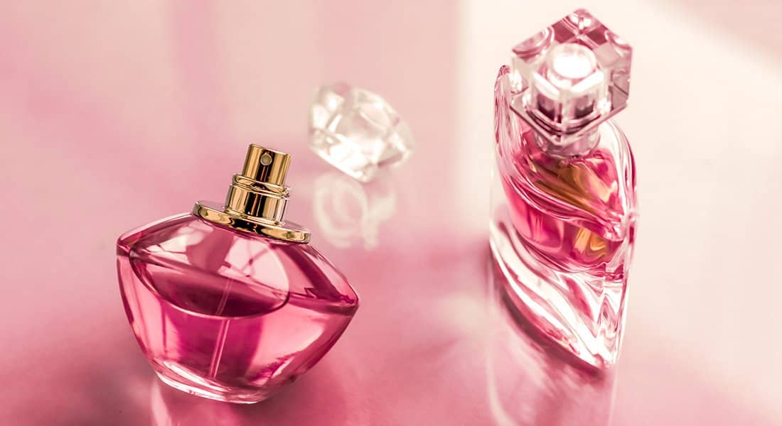 Pink perfume bottle on glossy background, sweet floral scent, glamour fragrance and eau de parfum as holiday gift and luxury beauty cosmetics brand