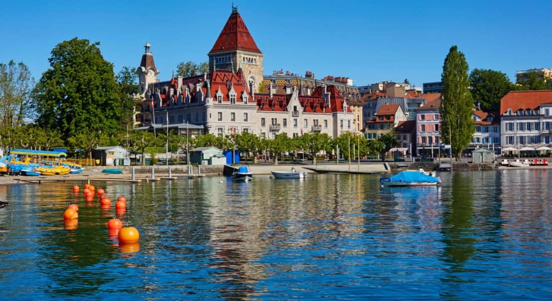 Skyline of Lausanne and the shoreline of Lake Geneva with 'Chateau de Ouchy' luxury hotel