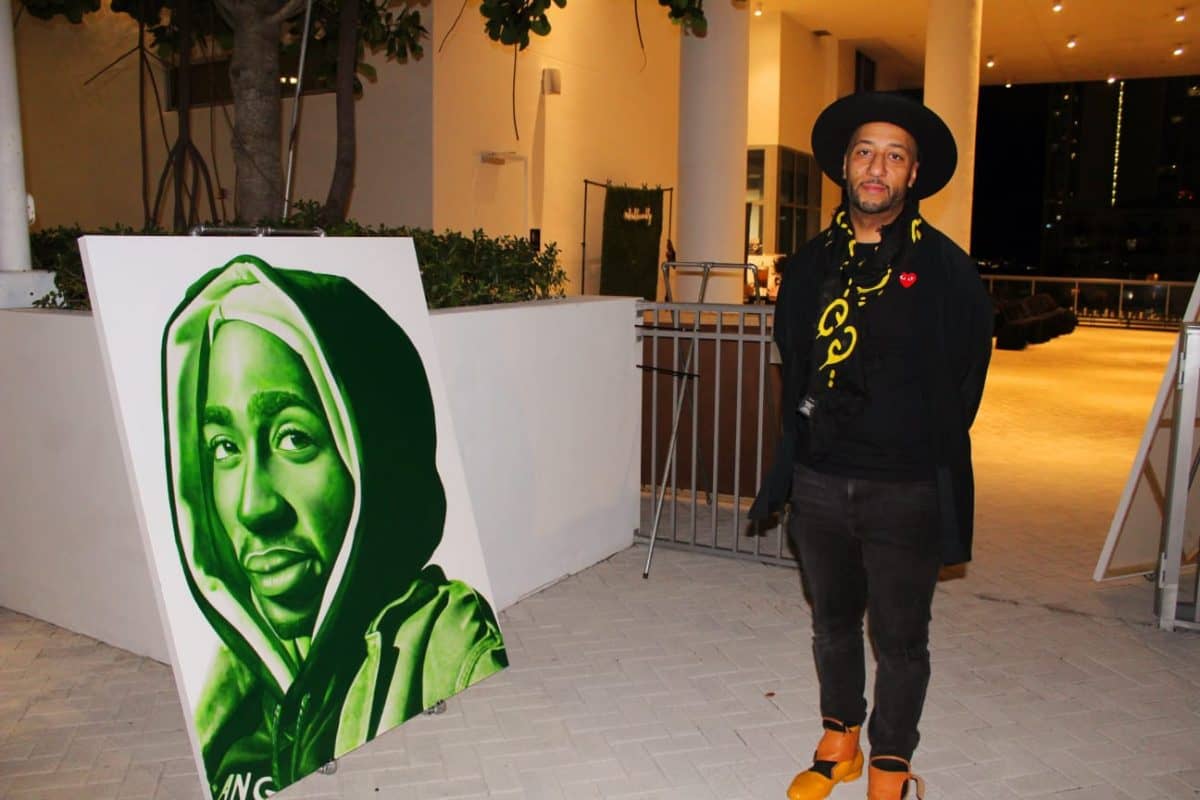 Artist Jeremy Turpin stands alongside one of his pieces at the Art of Love event held on December 8, 2023 in Miami Beach. 