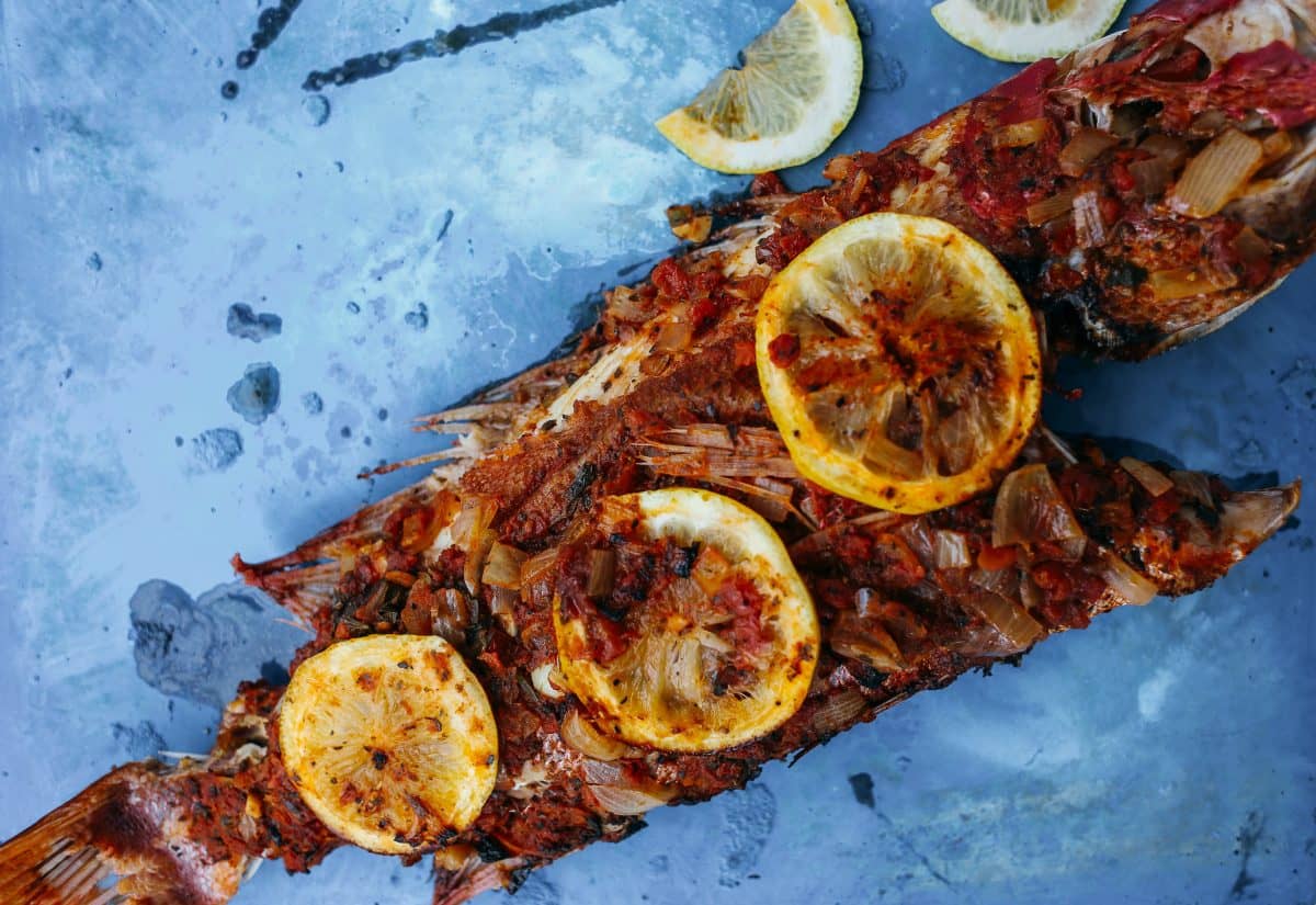 Grilled fish with sliced lemon is one of the food fare in Mombasa, Kenya. 