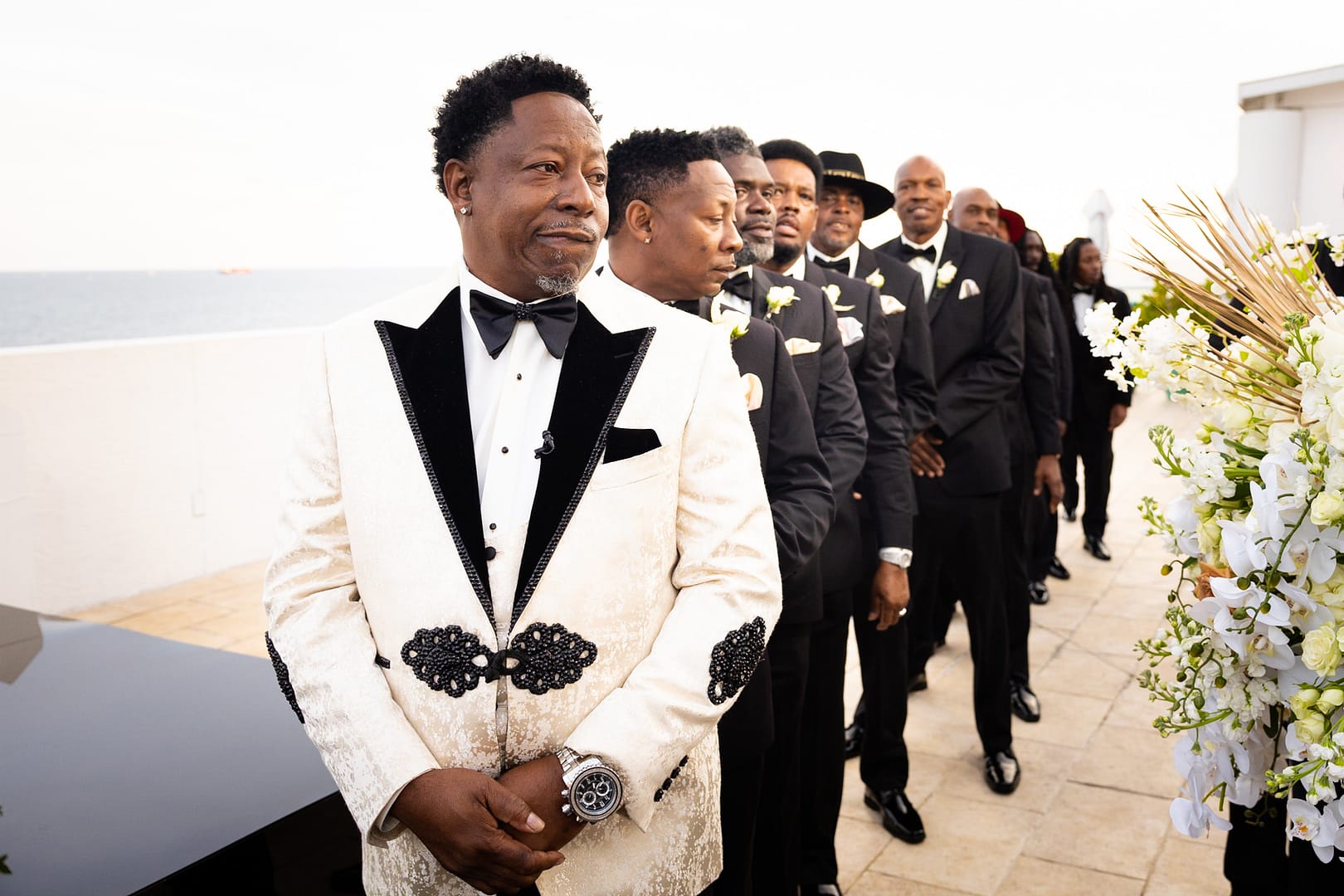 Groom in White Tux with Black Accents with Groomsmen in Black 