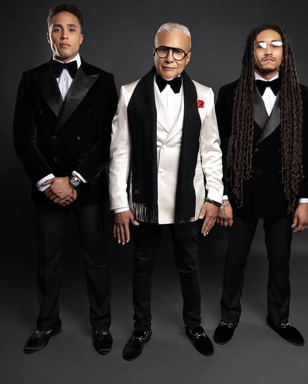 Men's fashion desinger miguel wilson in white tux with black scard and two men in velvet black tuxedos