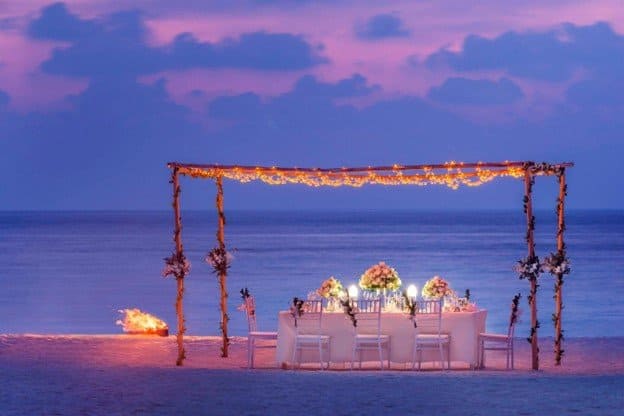 View of a romantic beachfront dinner at the St. Regis Maldives Vommuli Resort 