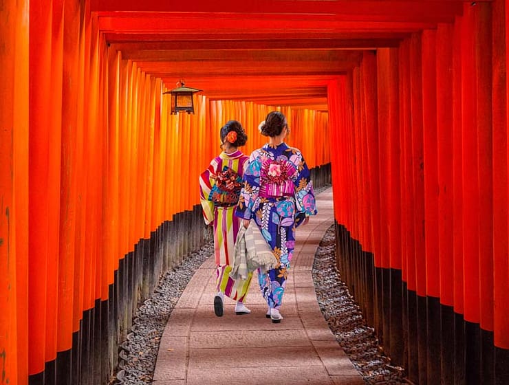 Women in traditional japanese kimonos walking at Fushimi Inari Shrine in Kyoto, Japan