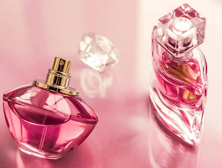Pink perfume bottle on glossy background, sweet floral scent, glamour fragrance and eau de parfum as holiday gift and luxury beauty cosmetics brand