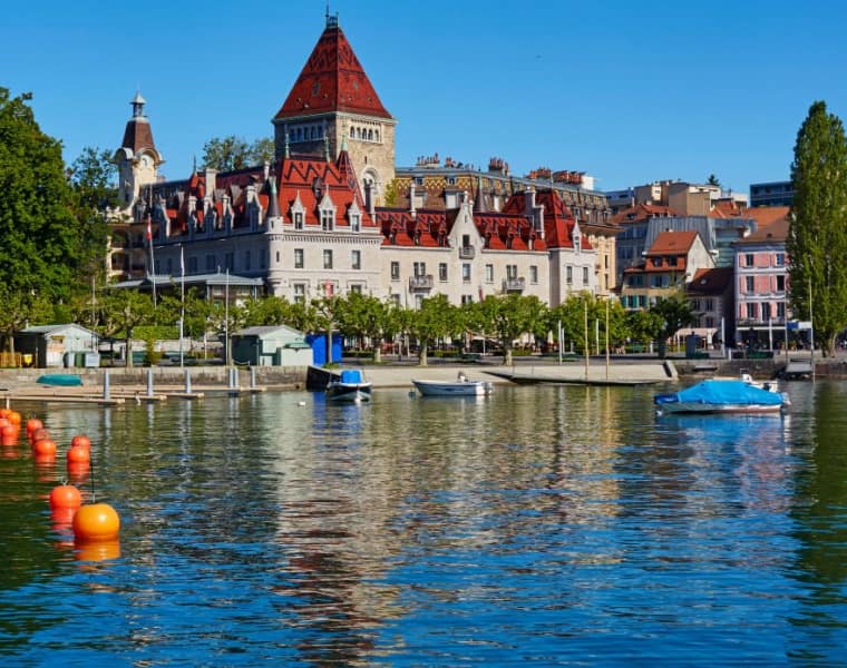 Skyline of Lausanne and the shoreline of Lake Geneva with 'Chateau de Ouchy' luxury hotel