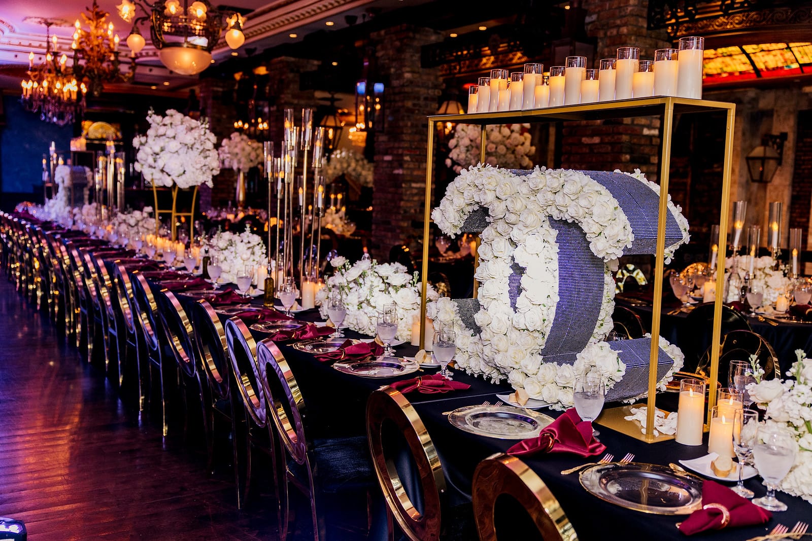 Luxurious Dark and Moody Wedding Reception Tablescape with Black and Gold Chairs with Burgundy Accents | Photographer Stanlo Photography